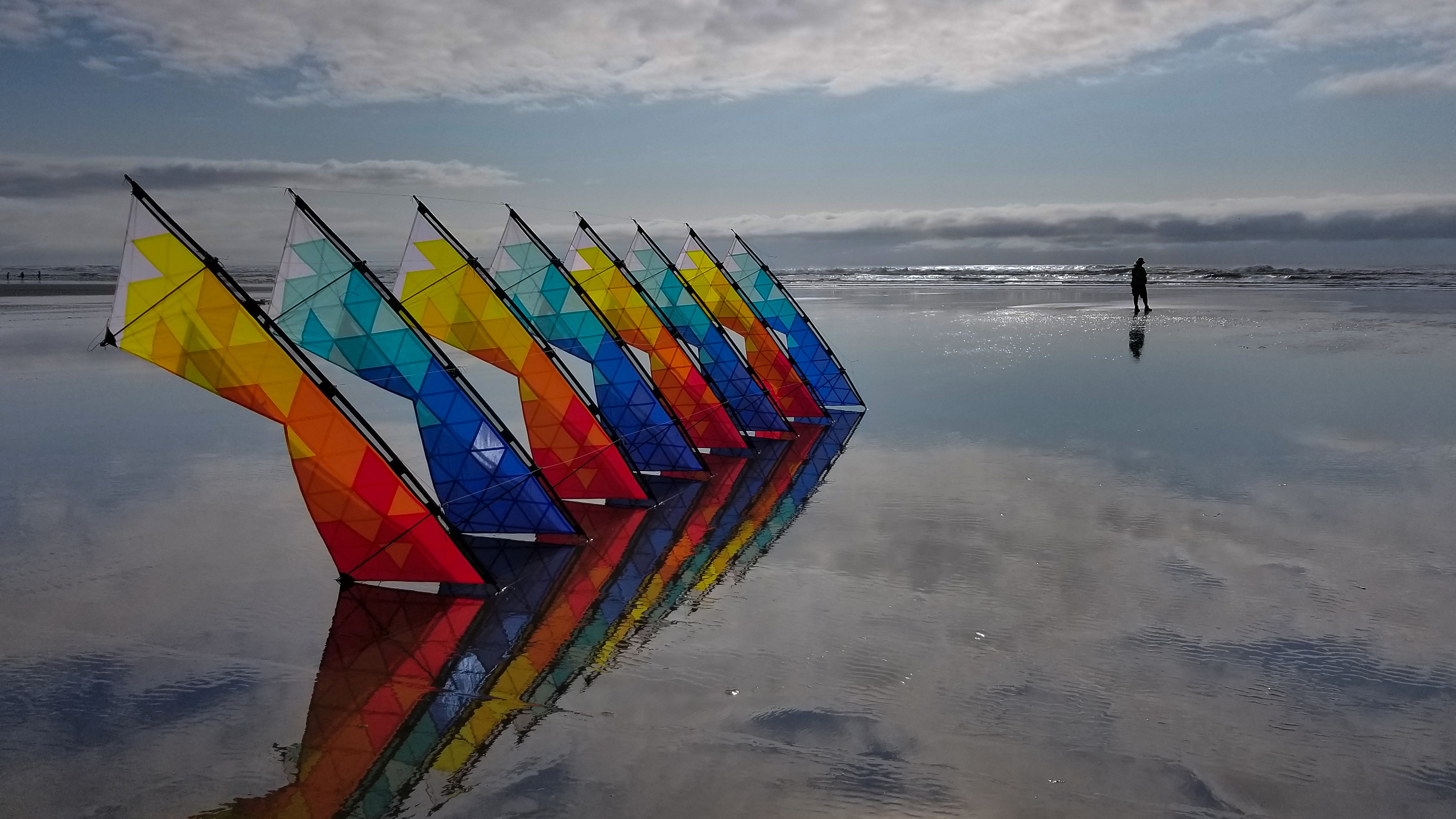 Mosaic sport kites landed with the flier in the background